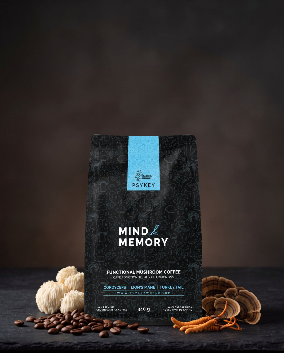 A high-angle view of whole coffee beans, dried Lion's Mane mushroom fruiting bodies, and a bag of PsyKey Mind & Memory coffee neatly arranged on a clean wooden surface.