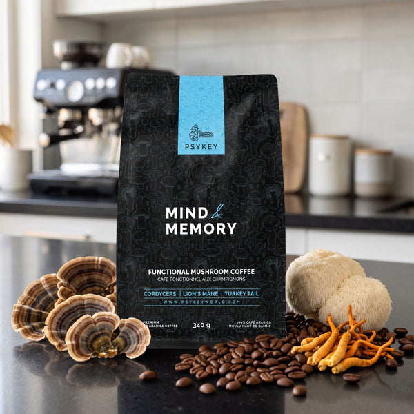 A 340g bag of PsyKey Mind & Memory functional mushroom coffee displayed on a modern kitchen counter alongside roasted coffee beans and raw Lion's Mane, Turkey Tail, and Cordyceps mushrooms.